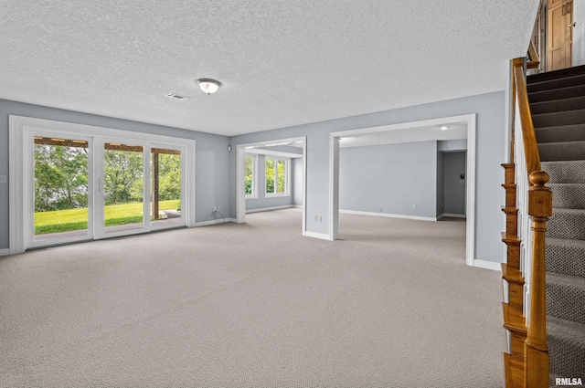 2 S Shore Ln, Rapids City, IL 61278 - spare room with stairs, light colored carpet, and a textured ceiling