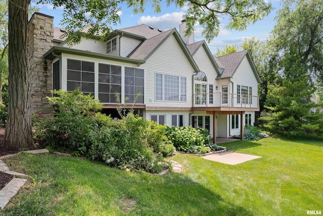 2 S Shore Ln, Rapids City, IL 61278 - rear view of house with a chimney, a yard, and a sunroom