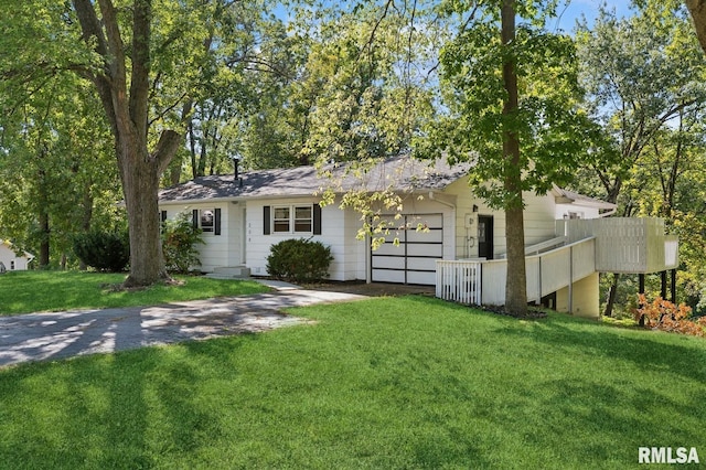 ranch-style house featuring a garage, driveway, and a front yard