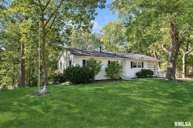 view of property exterior featuring an attached garage and a yard