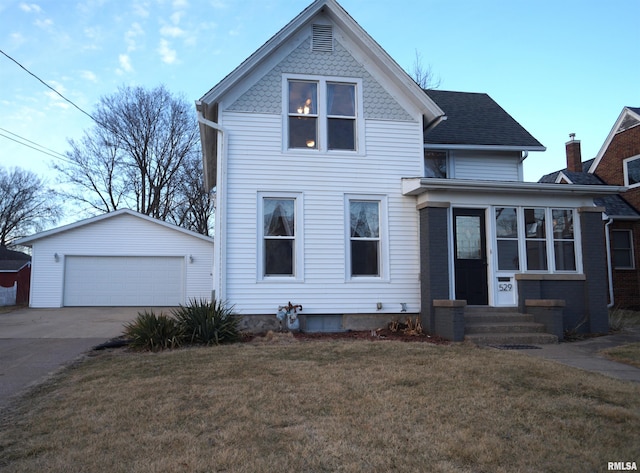 view of front facade featuring an outbuilding, a front lawn, a garage, and entry steps