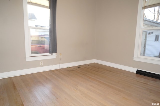 spare room with wood finished floors and baseboards