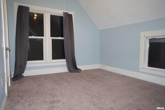 bonus room featuring lofted ceiling, carpet floors, and baseboards