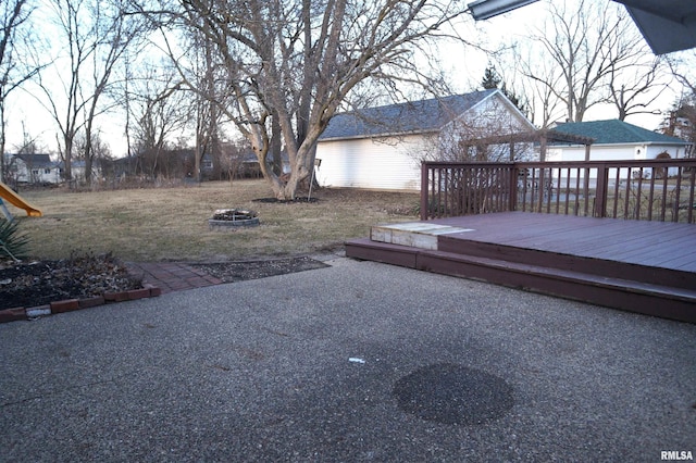 view of yard with an outdoor fire pit and a wooden deck