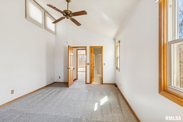 unfurnished room with high vaulted ceiling, a ceiling fan, baseboards, and carpet flooring