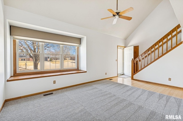 interior space with carpet, baseboards, visible vents, and stairway