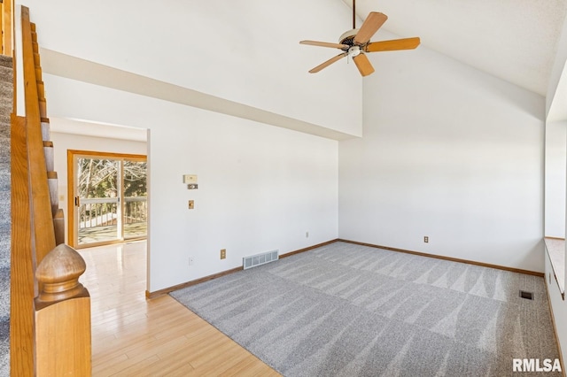 empty room featuring a ceiling fan, baseboards, visible vents, and wood finished floors