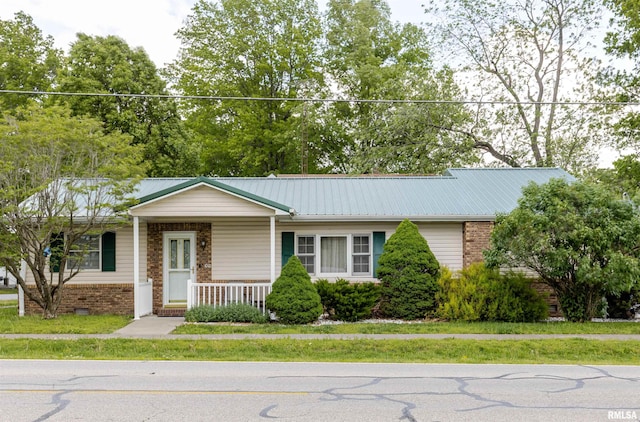 100 E Rea St, Valier, IL 62891 - ranch-style house featuring a porch, brick siding, and metal roof