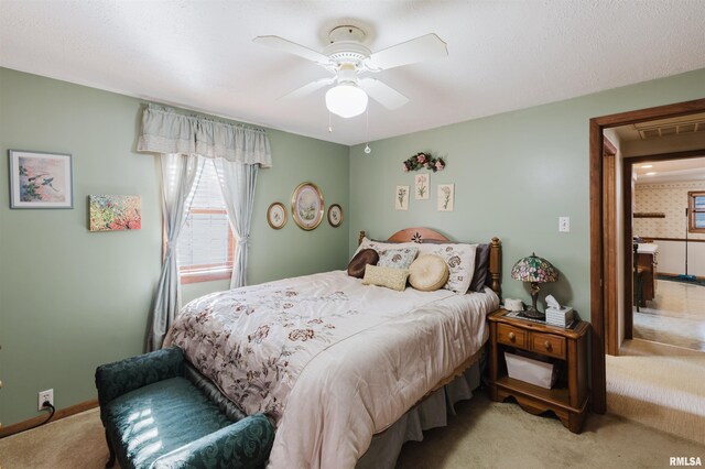 carpeted bedroom featuring a ceiling fan, visible vents, and baseboards