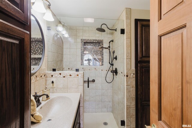 bathroom with a shower stall and vanity