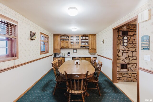 dining room with wallpapered walls and dark carpet