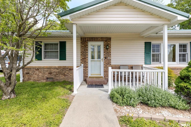 100 E Rea St, Valier, IL 62891 - view of front of house featuring a porch, crawl space, and brick siding