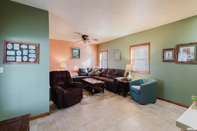 living room featuring ceiling fan, light tile patterned flooring, and baseboards