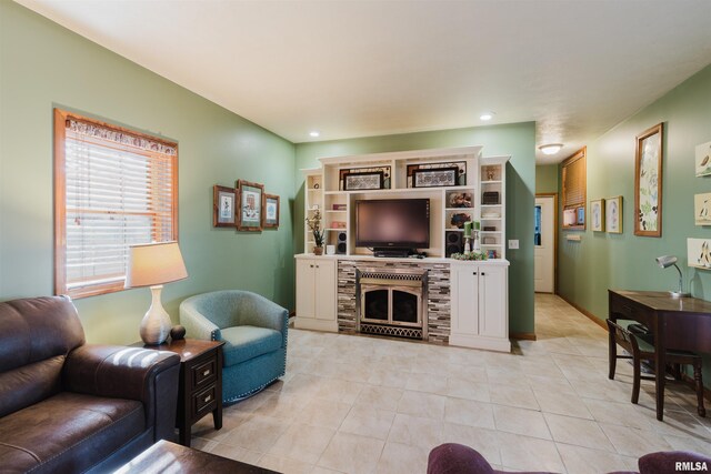 living area with light tile patterned floors, a fireplace, and recessed lighting