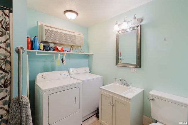 laundry area featuring laundry area, independent washer and dryer, a sink, and a wall mounted AC