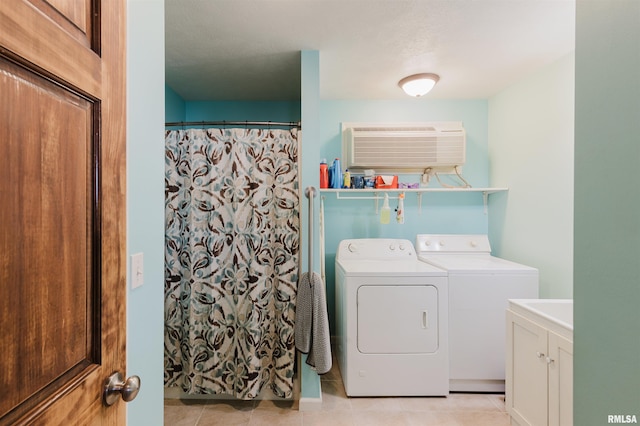 clothes washing area featuring laundry area, separate washer and dryer, a wall unit AC, and light tile patterned flooring