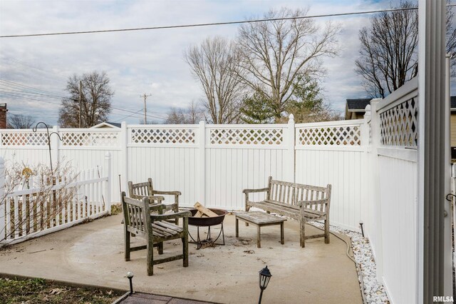 view of patio / terrace featuring an outdoor fire pit and a fenced backyard