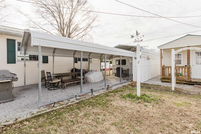 view of yard with a carport and fence