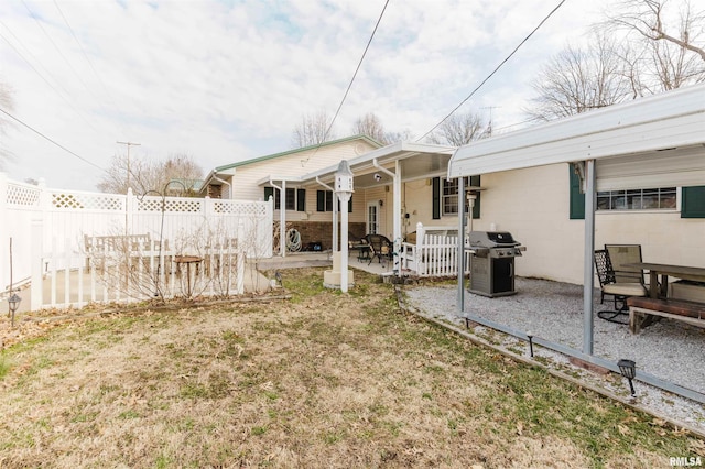 back of house featuring concrete block siding, a patio area, and fence