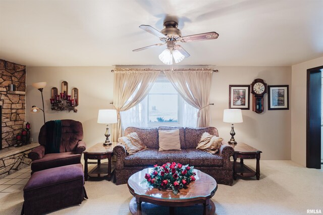 carpeted living room with a fireplace and a ceiling fan