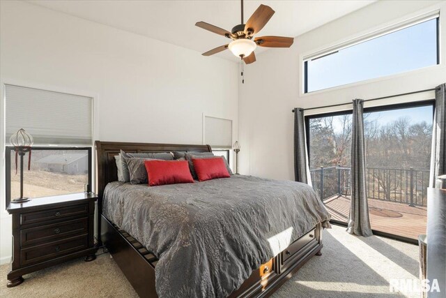 bedroom featuring access to outside, carpet flooring, ceiling fan, and a towering ceiling