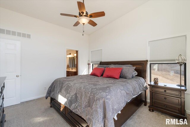 bedroom featuring visible vents, baseboards, ensuite bathroom, carpet, and high vaulted ceiling