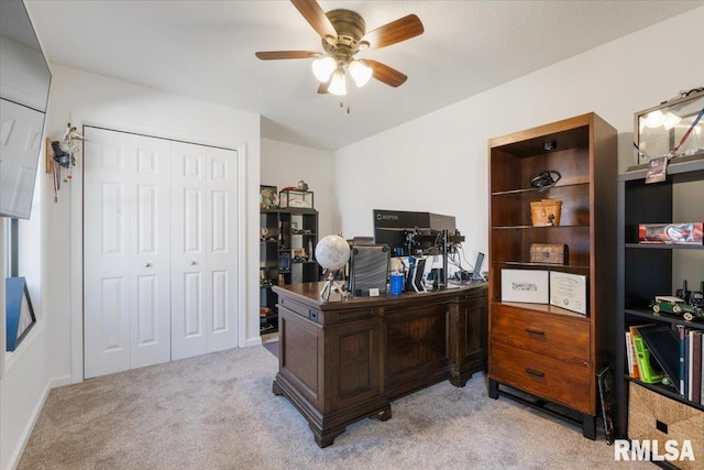 home office featuring light carpet and ceiling fan