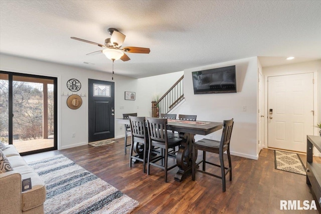 dining room featuring baseboards, stairway, dark wood finished floors, and a textured ceiling