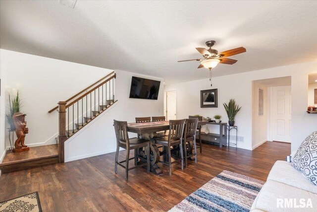 dining room featuring ceiling fan, wood finished floors, visible vents, baseboards, and stairway