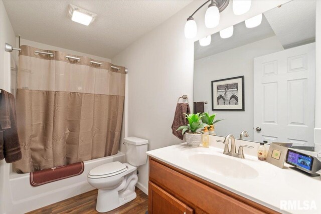 full bathroom with shower / bath combination with curtain, toilet, a textured ceiling, vanity, and wood finished floors