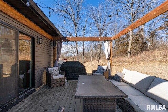 wooden deck with a grill and an outdoor hangout area