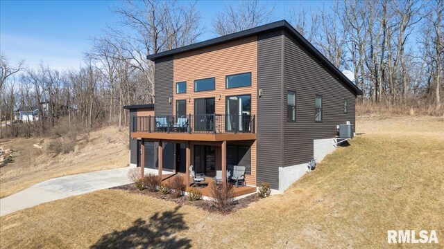 view of property exterior featuring a patio, an attached garage, central AC, a yard, and concrete driveway