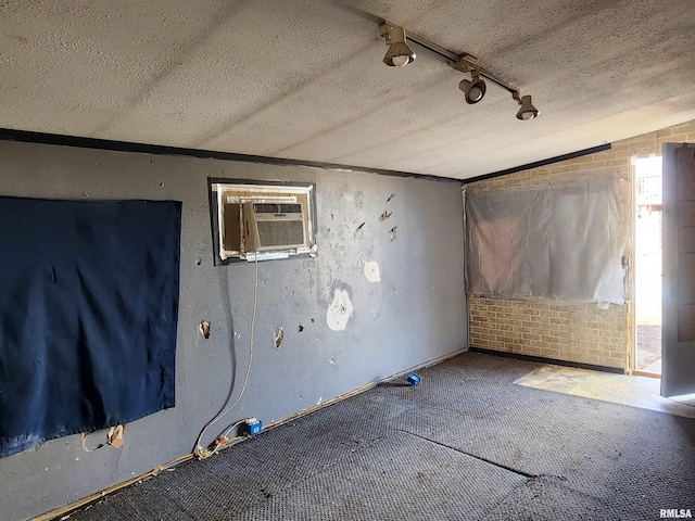 unfurnished room with a textured ceiling