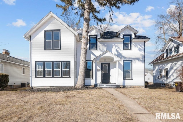 view of front of house featuring a front lawn and central AC unit