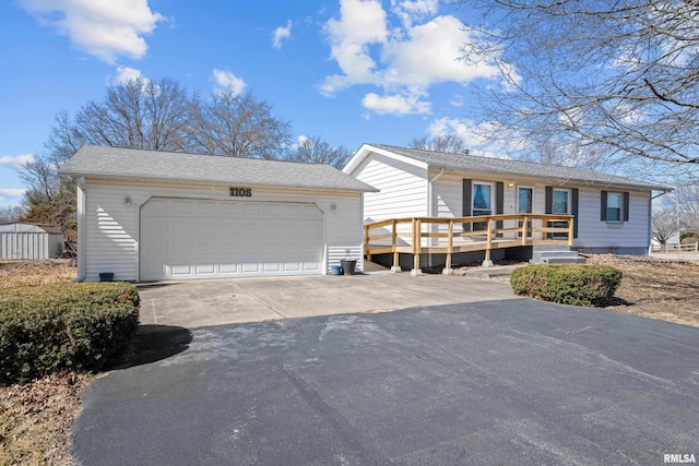 ranch-style home with a garage, an outdoor structure, and a deck