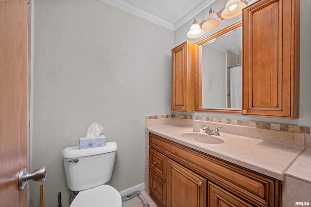 bathroom featuring ornamental molding, vanity, and toilet