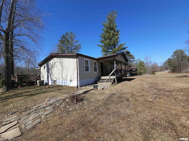 view of home's exterior featuring crawl space, covered porch, and cooling unit