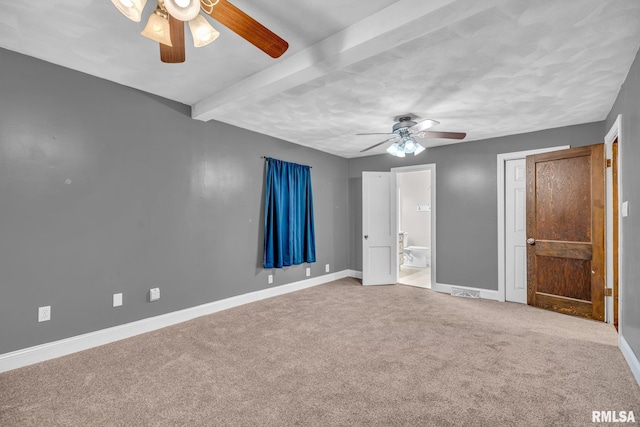 unfurnished bedroom featuring carpet, baseboards, ceiling fan, and beam ceiling