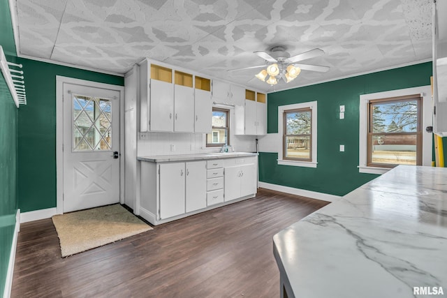 kitchen featuring dark wood-style floors, light countertops, and baseboards