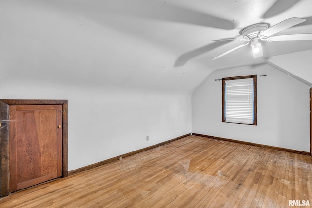 bonus room with lofted ceiling, light wood finished floors, and baseboards