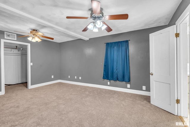 unfurnished bedroom with carpet floors, visible vents, baseboards, and a ceiling fan