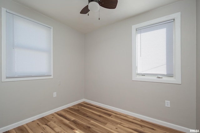 unfurnished room featuring ceiling fan, wood finished floors, and baseboards