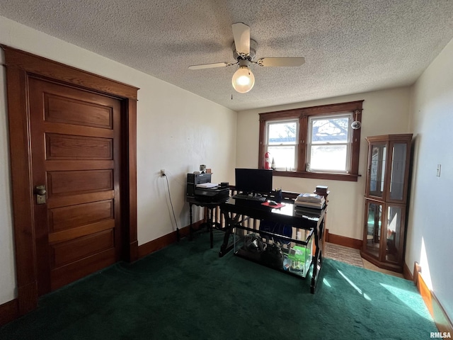 carpeted home office with a ceiling fan, a textured ceiling, and baseboards