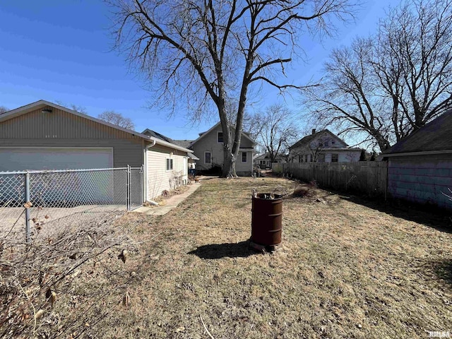 view of yard featuring a garage and fence