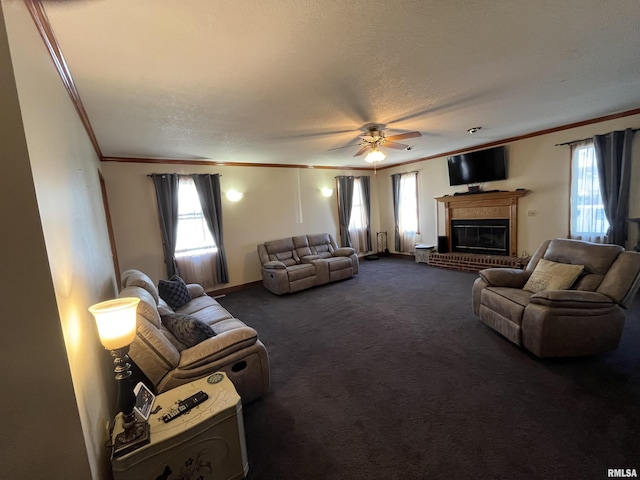 living area with ornamental molding, dark carpet, and a healthy amount of sunlight