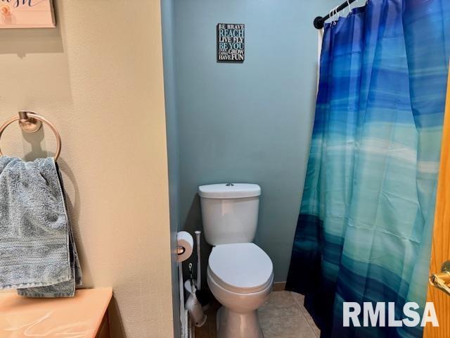 full bathroom with a shower with curtain, vanity, toilet, and tile patterned floors