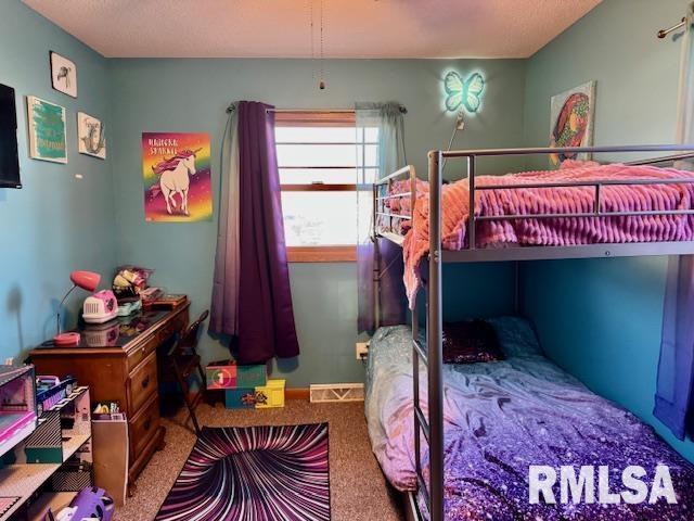 bedroom with carpet, visible vents, and baseboards