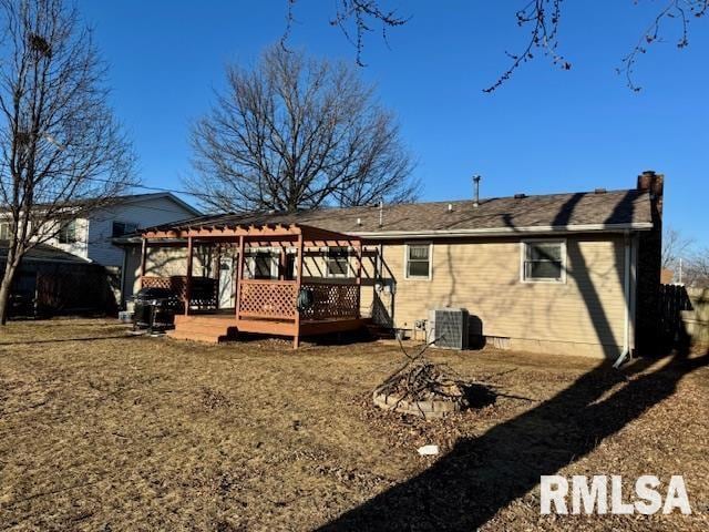 back of house featuring a chimney, a deck, a pergola, and central AC unit