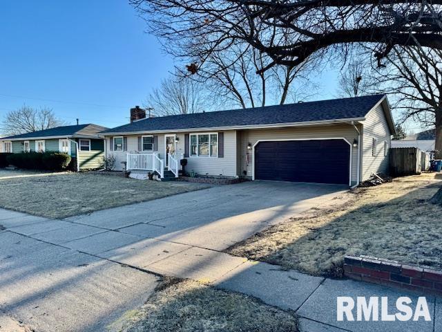 ranch-style home with a garage, concrete driveway, and a chimney