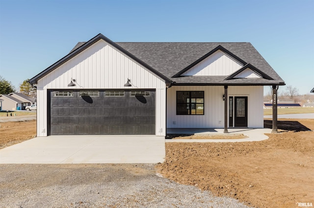 modern farmhouse with a porch, concrete driveway, roof with shingles, and an attached garage